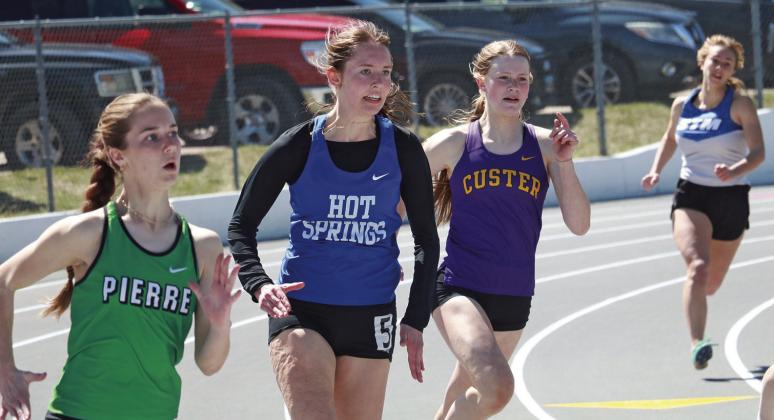 Hot Springs senior Maggie Preuss makes the turn during the 200-meters of the Rapid City Track-O-Rama last Friday, April 12. She PR’d in this event with a time of 28.54 which placed her 28th overall. Preuss was also part of the 4x400m relay which placed second with a 4:15.58. Photo by Brett Nachtigall/Fall River County Herald-Star