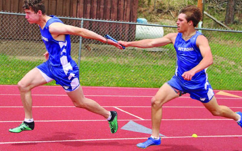Hot Springs’ Hunter Kunz hands off the baton to Luke Haertel in the 4x200m relay at last week’s Last Chance Meet in Custer. Photo by Jason Ferguson/Custer County Chronicle