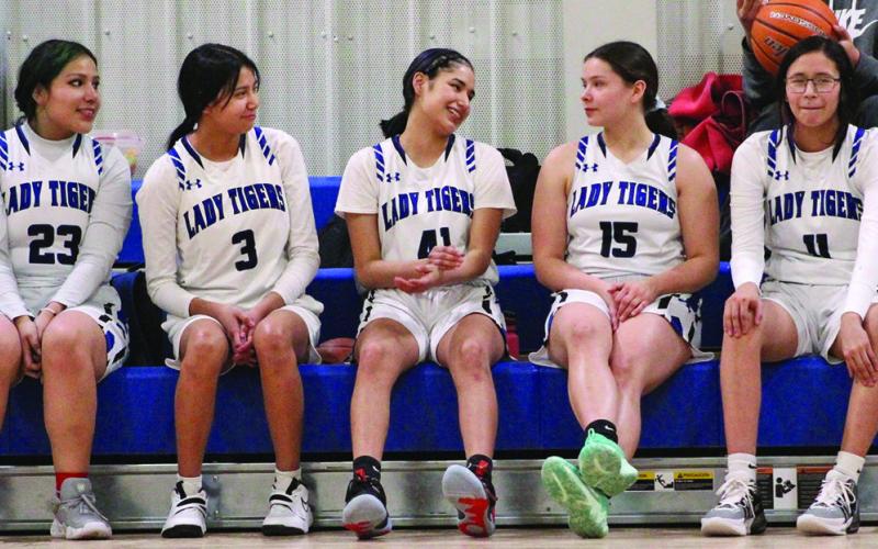 The Lady Tigers, from left to right: Blanche Mousseaux, Nalolah Warrior, Katelyn Her Many Horses, Amelia Her Many Horses, and Isabella Her Many Horses, take a much-needed rest during halftime of Friday night’s game against Edgemont. Photo by Masha Fehr