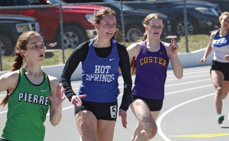 Hot Springs senior Maggie Preuss makes the turn during the 200-meters of the Rapid City Track-O-Rama last Friday, April 12. She PR’d in this event with a time of 28.54 which placed her 28th overall. Preuss was also part of the 4x400m relay which placed second with a 4:15.58. Photo by Brett Nachtigall/Fall River County Herald-Star