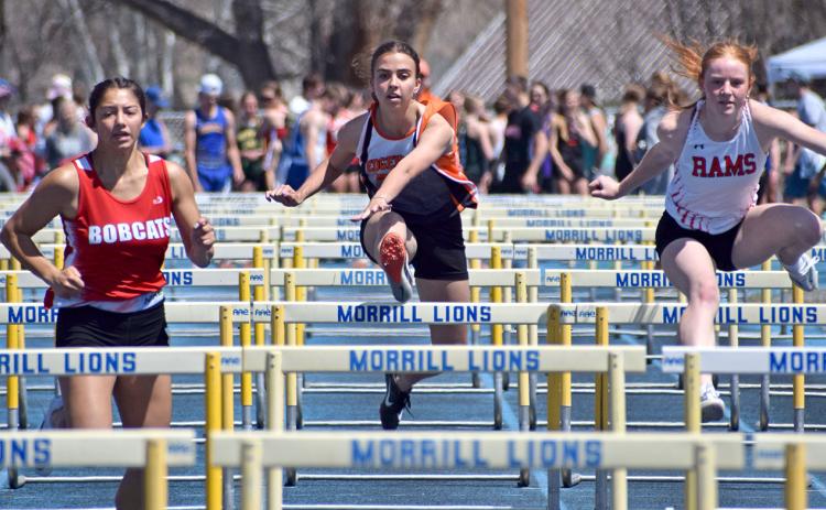 Tavian Urban, center, pushes her limits to set a personal record in the 100-meter hurdles of the Panhandle Conference track meet last week. Photo by Sam Miller